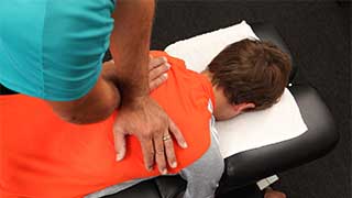 A chiropractor doing spine adjustments